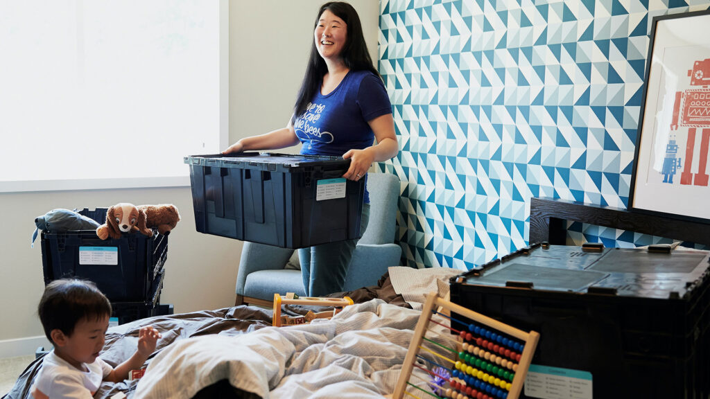 woman carrying a box unpacking her new home, just got term life insurance