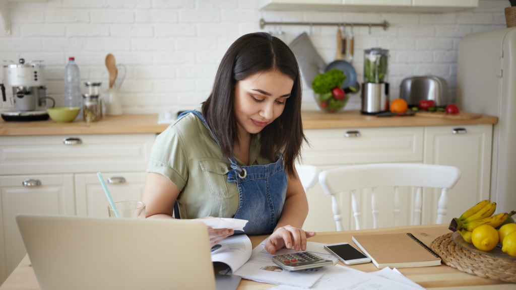 woman paying bills using debt free life program