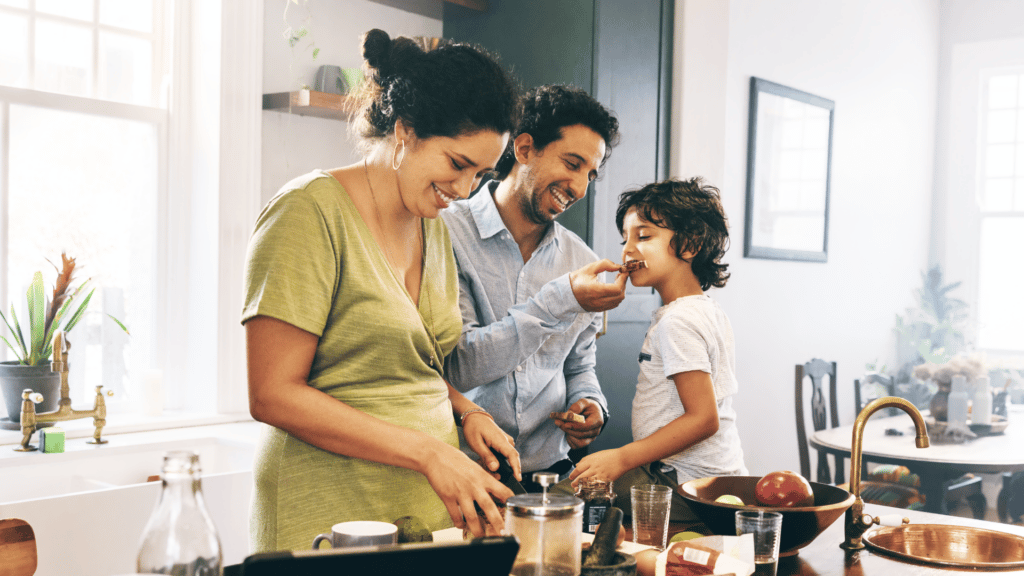 mother father and child in kitchen cooking together