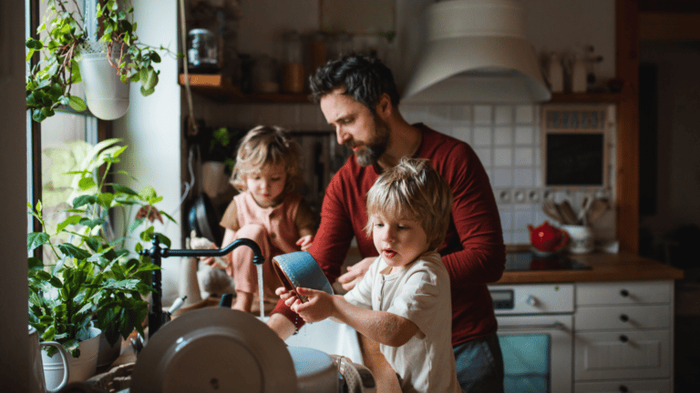 father and two daughters in kitchen