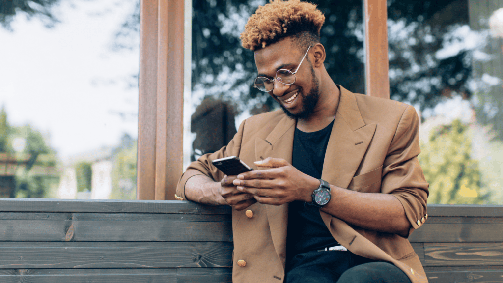 man sitting outside looking at cell phone