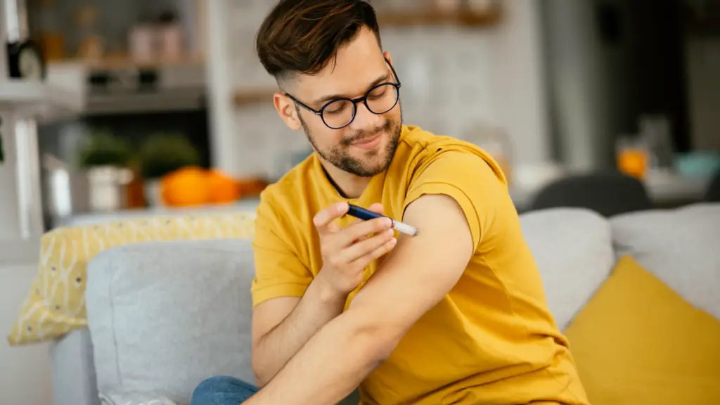 man with diabetes using insulin shot