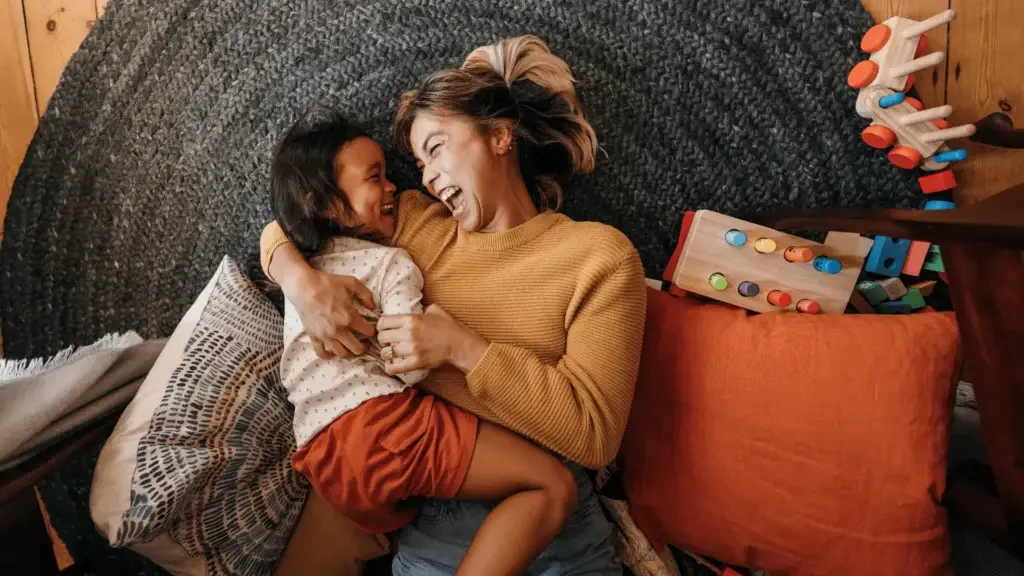 woman and daughter sitting on couch together